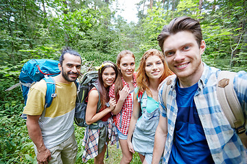 Image showing friends with backpack taking selfie in wood