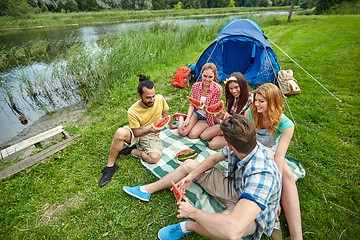 Image showing happy friends eating watermelon at camping