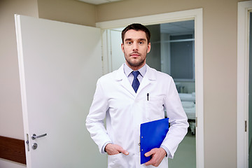 Image showing doctor with clipboard at hospital corridor