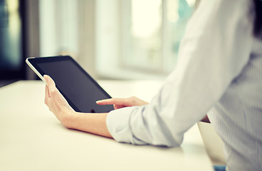 Image showing close up of woman hands with tablet pc at office