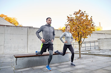 Image showing couple doing lunge exercise on city street