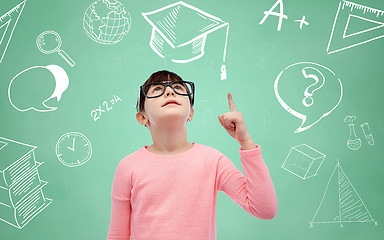 Image showing happy little girl in eyeglasses pointing finger up