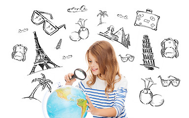Image showing student girl looking at globe with magnifier