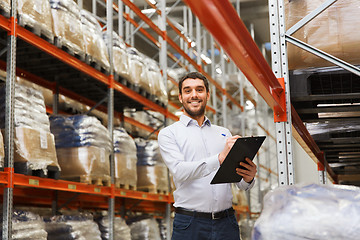 Image showing businessman with clipboard at warehouse