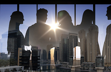 Image showing people silhouettes over city background