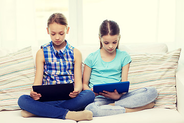 Image showing girls with tablet pc sitting on sofa at home