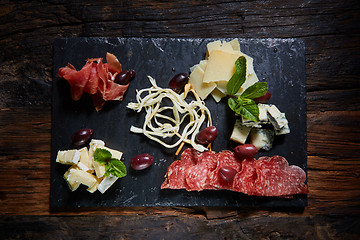 Image showing Salami and cheese platter with herbs