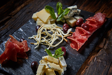 Image showing Salami and cheese platter with herbs