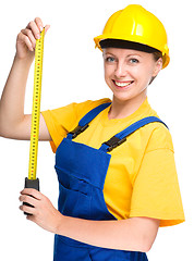 Image showing Young construction worker with tape measure