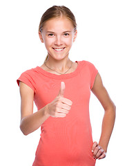 Image showing Young girl is showing thumb up gesture