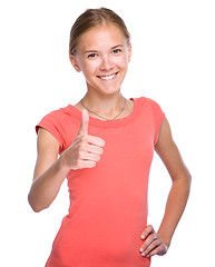 Image showing Young girl is showing thumb up gesture