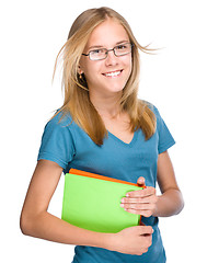 Image showing Young student girl is holding book