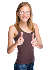 Image showing Woman is showing thumb up gesture