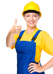 Image showing Young construction worker is showing thumb up sign