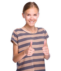 Image showing Young girl is showing thumb up gesture