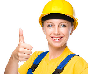 Image showing Young construction worker is showing thumb up sign