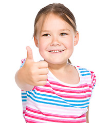 Image showing Little girl is showing thumb up gesture