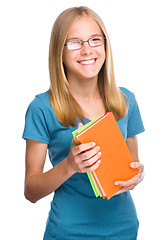 Image showing Young student girl is holding book