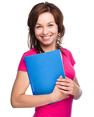 Image showing Young student girl is holding exercise book