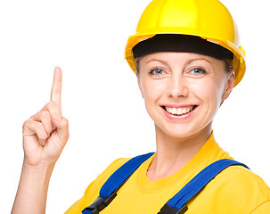 Image showing Young construction worker pointing up