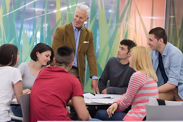 Image showing teacher with a group of students in classroom