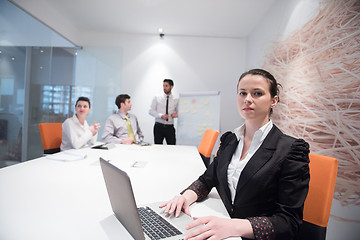 Image showing young business woman on meeting  using laptop computer