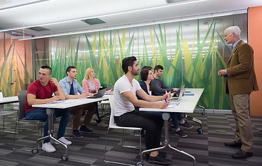 Image showing teacher with a group of students in classroom