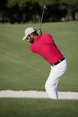 Image showing golfer hitting a sand bunker shot