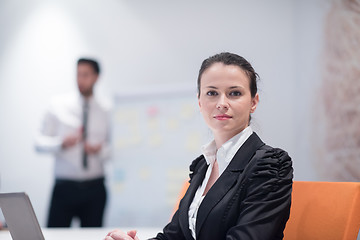 Image showing young business woman on meeting  using laptop computer