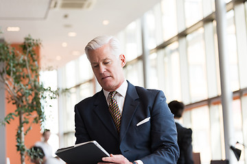 Image showing senior business man working on tablet computer