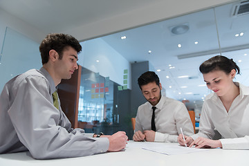 Image showing young couple signing contract documents on partners back