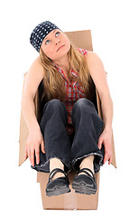 Image showing Girl sitting in a cardboard box, looking up