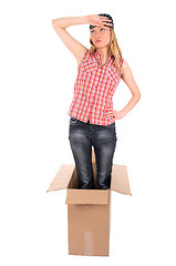 Image showing Tired girl standing in a cardboard box