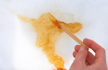 Image showing Maple taffy on snow