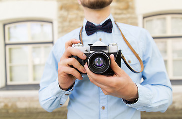 Image showing close up of hipster man with film camera in city