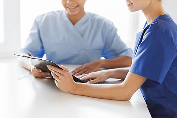 Image showing close up of doctors with clipboard at hospital