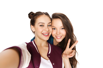 Image showing happy friends taking selfie and showing peace