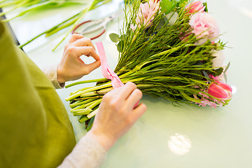 Image showing close up of woman making bunch at flower shop