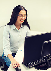 Image showing smiling businesswoman or student with eyeglasses