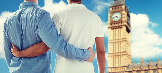 Image showing close up of male gay couple hugging over big ben