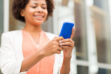 Image showing close up of african woman with smartphone in city