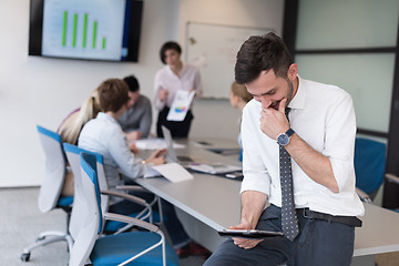 Image showing young business man with tablet at office meeting room