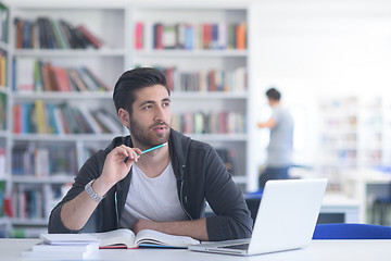 Image showing student in school library using laptop for research