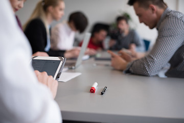 Image showing close up of  businessman hands  using tablet on meeting