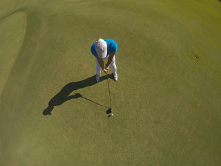 Image showing top view of golf player hitting shot