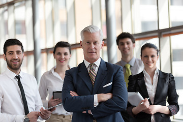 Image showing portrait of senior businessman as leader  with group of people i