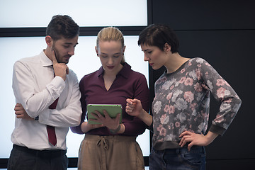 Image showing young business people group working on tablet