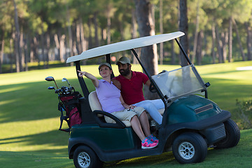 Image showing couple in buggy on golf course