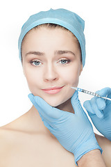 Image showing Attractive woman at plastic surgery with syringe in her face