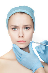 Image showing Attractive woman at plastic surgery with syringe in her face